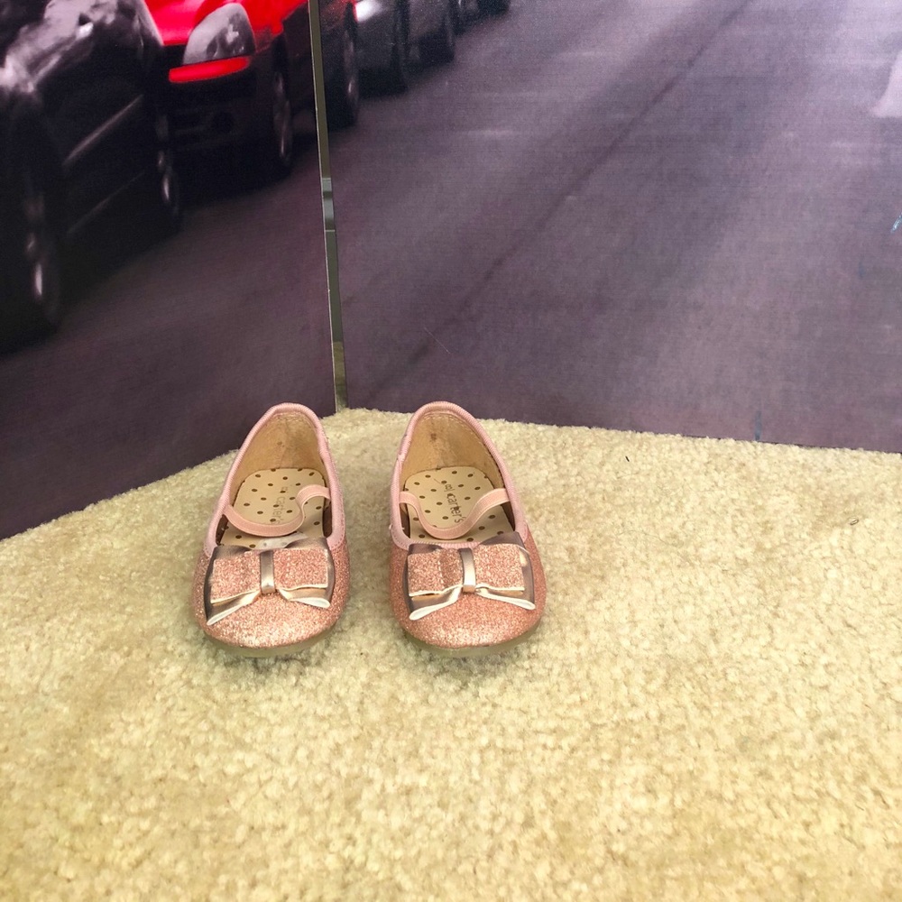 Rose gold sparkly flat shoes.